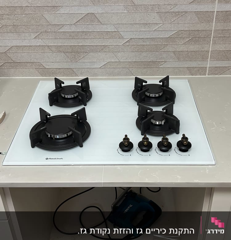 כיריים גז עם ארבעה מבערים וכפתורי שליטה